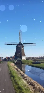 Scenic windmill under a blue sky with a rural landscape view.