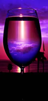 Sunset reflected in a wine glass against a purple sky.