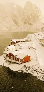 Snowy coastal scene with red cabins and calm water.