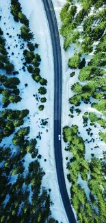 Aerial view of a scenic winter forest road surrounded by snow and green trees.