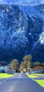 Serene snowy mountain road with houses.