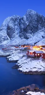 Snowy mountain village with red cabins and a blue sky.