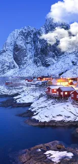 Snowy village with mountains at sunset.