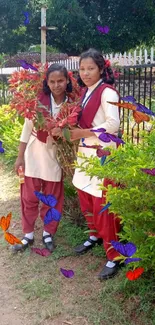 Two schoolgirls with red leaves in nature setting.