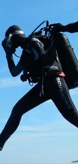 Scuba diver jumping into blue ocean from boat.