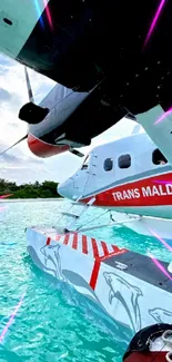 Seaplane on turquoise waters in Maldives with blue sky.