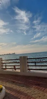 Seaside view with sunset and ocean under a blue sky.