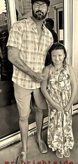 Sepia-toned family portrait with smiling father and daughter.