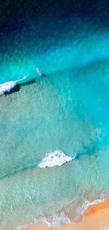 Aerial view of a serene ocean with vibrant aqua hues and gentle waves.