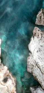 Aerial view of turquoise ocean and rugged rocky shoreline.