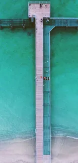 Aerial view of a wooden pier over turquoise waters, creating a soothing wallpaper.