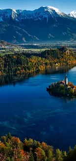 Alpine lake with autumn colors and snow-capped mountains.