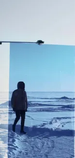 Person walking reflected in blue glass on snowy landscape.