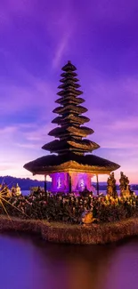 Bali temple at sunset with purple skies over a tranquil lake, perfect mobile wallpaper.