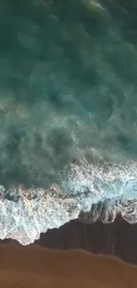 Aerial view of turquoise ocean waves on a sandy beach.