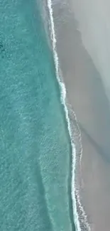 Aerial view of turquoise ocean meeting sandy beach.