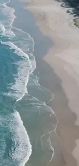 Aerial view of a serene beach with gentle ocean waves.