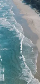 Aerial view of calm beach waves and sandy shore from above.