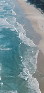 Aerial view of tranquil beach with turquoise ocean waves and sandy shore.