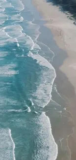 Aerial view of a serene beach with waves and sand.