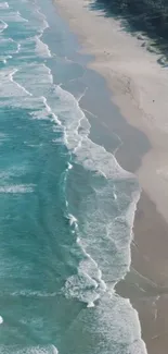 Aerial view of a serene beach with turquoise waves and sandy shore.