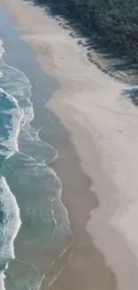 Aerial view of a serene beach with blue waves and sandy shores.