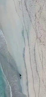 Aerial view of a serene beach with turquoise waters and sandy shores.