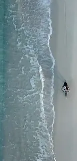 Aerial view of a serene beach with waves and sand.