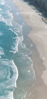 Aerial view of a serene beach with turquoise waves and sandy shore.