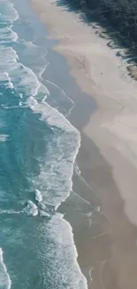 Aerial view of the beach with vibrant blue waves and sandy shore.