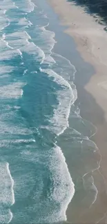 Aerial view of blue ocean waves along a sandy beach.