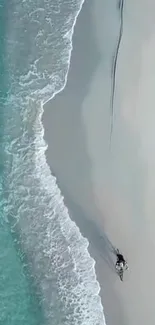 Aerial view of a serene beach with turquoise waters and white sands.