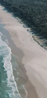 Aerial view of a serene beach with turquoise waves and soft sand.