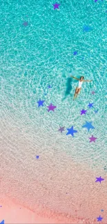 Aerial view of a swimmer in turquoise water above pink sand beach.