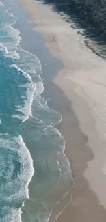 Aerial view of a serene beach with waves and blue ocean water.