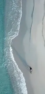 Aerial view of a serene beach with turquoise waters and soft sand.