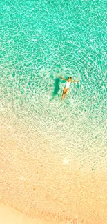 Aerial view of beach with clear turquoise water and sandy shore.