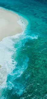 Aerial view of a serene beach with aqua blue waters and white sandy shore.