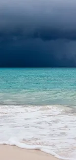 A serene beach with waves under a dramatic dark sky.