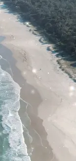 A peaceful beach with waves and a forest.