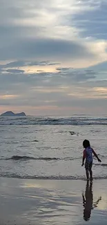 Child walking on beach at sunset with calming ocean waves.