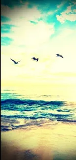 Serene beach scene with birds flying over ocean.