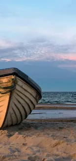 Boat resting on serene beach with pastel sky and ocean waves.