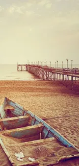 Serene beach with a rustic boat and wooden pier under a clear sky.