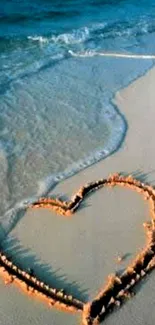 Heart drawn in sand by the ocean, captured at the beach.