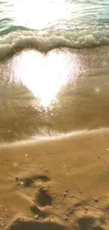 Heart-shaped reflection on beach sand with ocean waves.