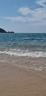 Serene beach wallpaper with waves and a clear blue sky.