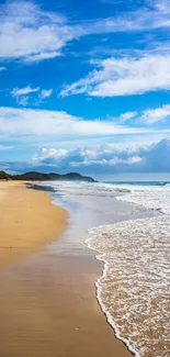 Serene beach scene with sandy shores and blue sky for mobile wallpaper.