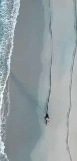 A motorcycle rides along a serene beach with ocean waves and sandy shore.