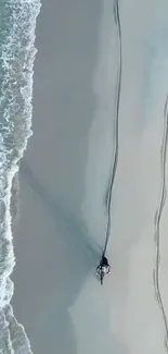 A motorcycle rides along a serene beach with ocean waves.